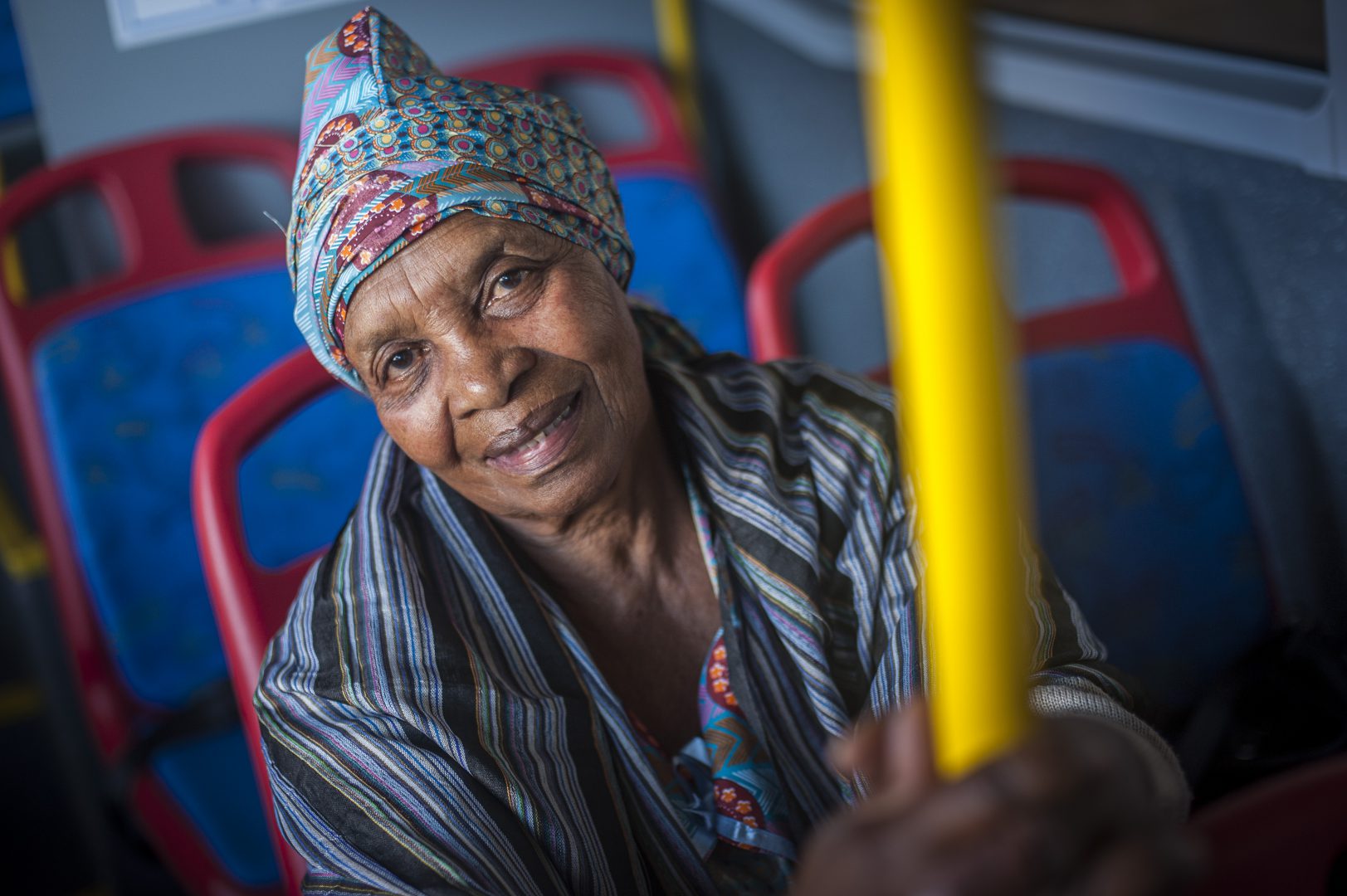 Elderly woman sitting in bus seat